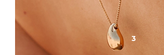 Gold-plated necklace with pendant worn by a women