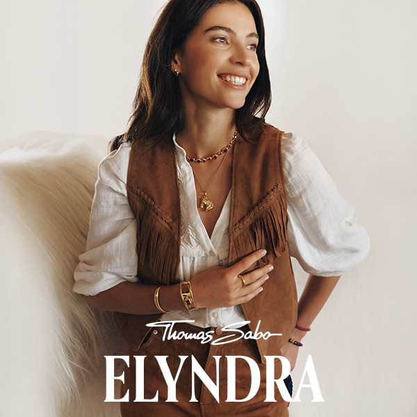 Woman wearing multiple gold-plated pieces from the exclusive Elyndra signature jewellery collection