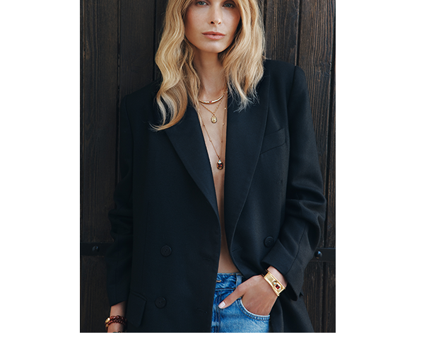 Image showing a woman wearing multiple gold-plated jewellery pieces from the Elyndra collection