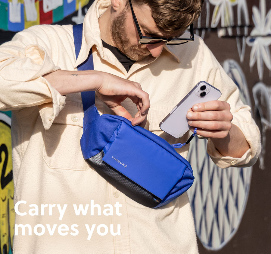 Lifestyle image of a model wearing the Miles Chest Pack with text "Carry what moves you"