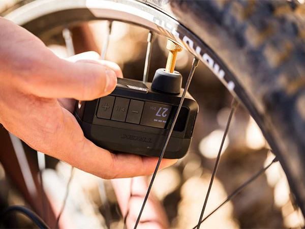 Cyclist using Air Rush pump to inflate tire