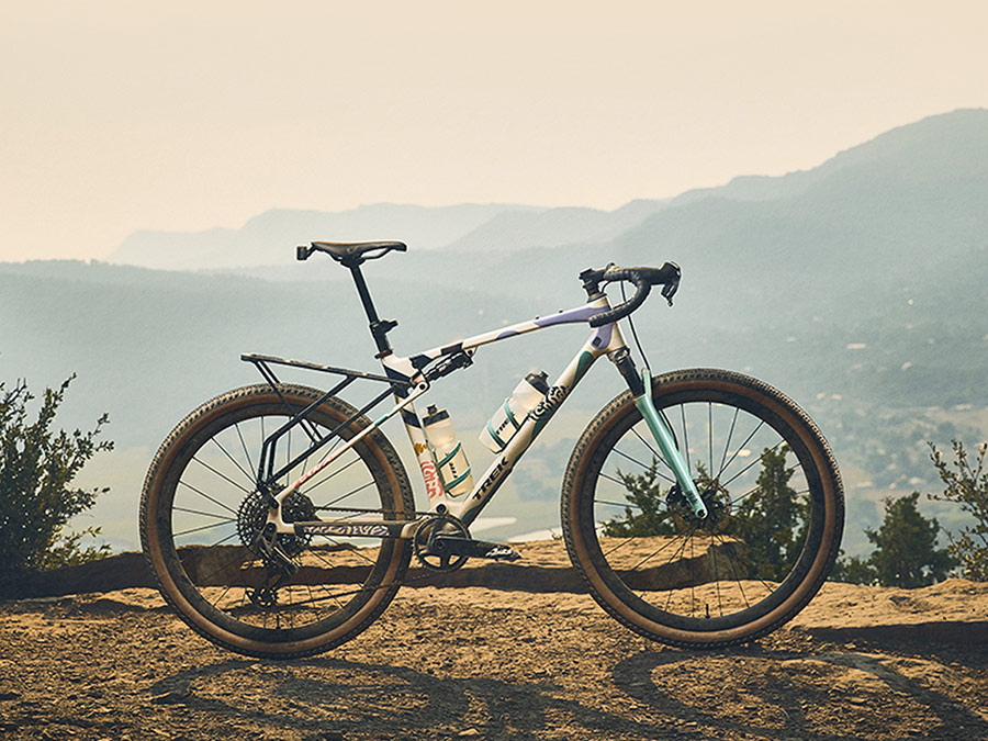All-new CheckOUT bike on rocky mountain top with more mountains in background