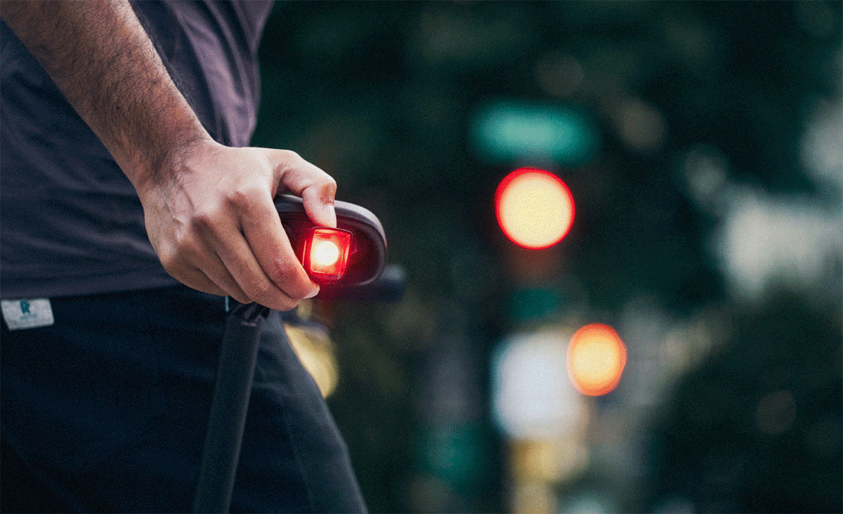 Slideshow of cyclists riding bikes outside with daytime running lights turned on