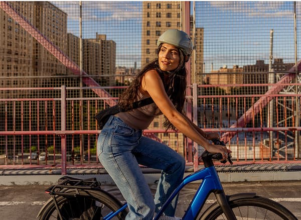 Lifestyle shot of a cyclist wearing a helmet on City bike
