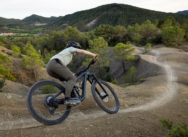 Lifestyle shot of a cyclist wearing a helmet on mountain bike