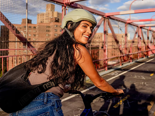 Lifestyle shot of a cyclist wearing a helmet on City bike