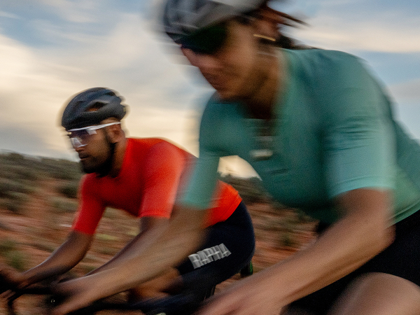Lifestyle shot of a cyclist wearing a helmet on road bike