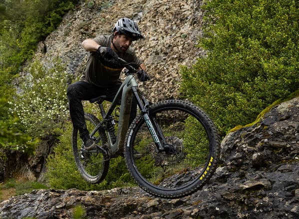 Lifestyle shot of a cyclist wearing a helmet on Electric bike