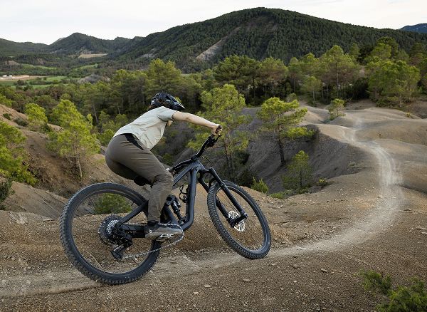Lifestyle shot of a cyclist wearing a helmet on mountain bike