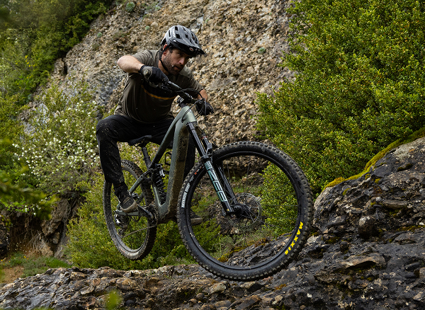 Lifestyle shot of a cyclist wearing a helmet on Electric bike