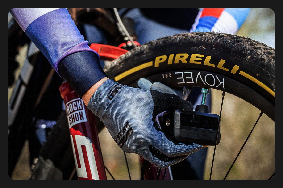 Cyclist inflating tire using all-new Air Rush Electric Pump