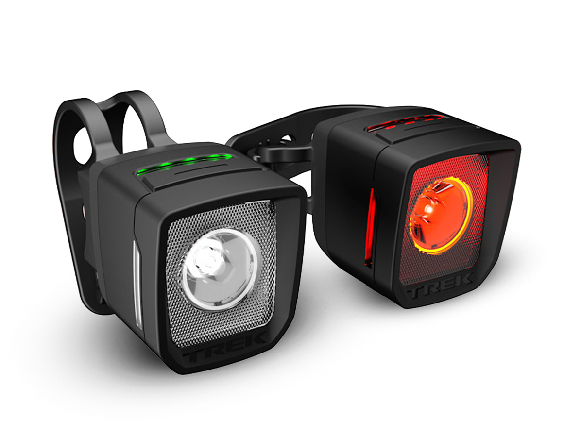 Trek daytime running lights front and rear set against dark background