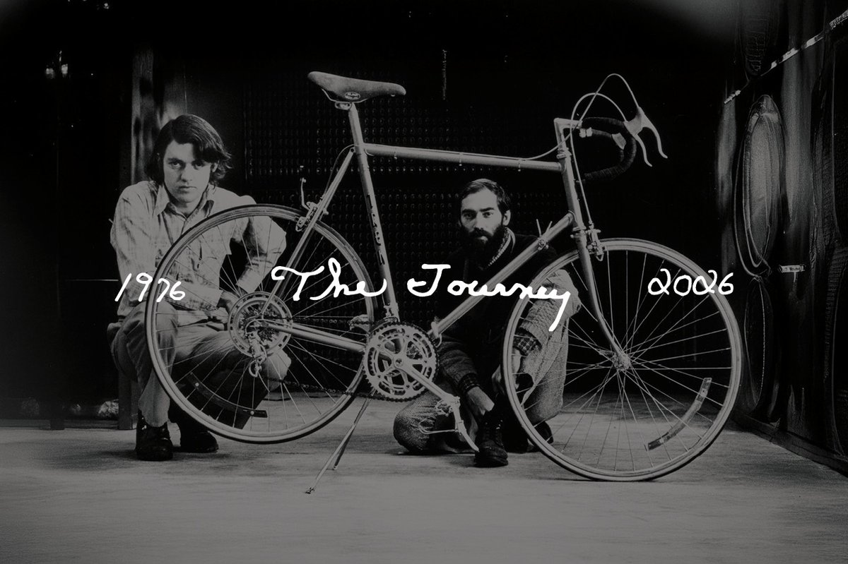Black-and-white photo of two people kneeling beside an early Trek bicycle, with handwritten text reading 1976, The Journey, 2076