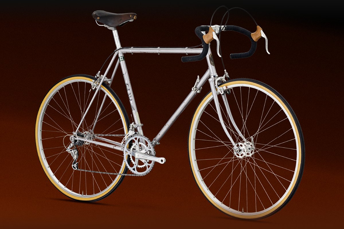 Silver vintage Trek road bike against a dark gradient background