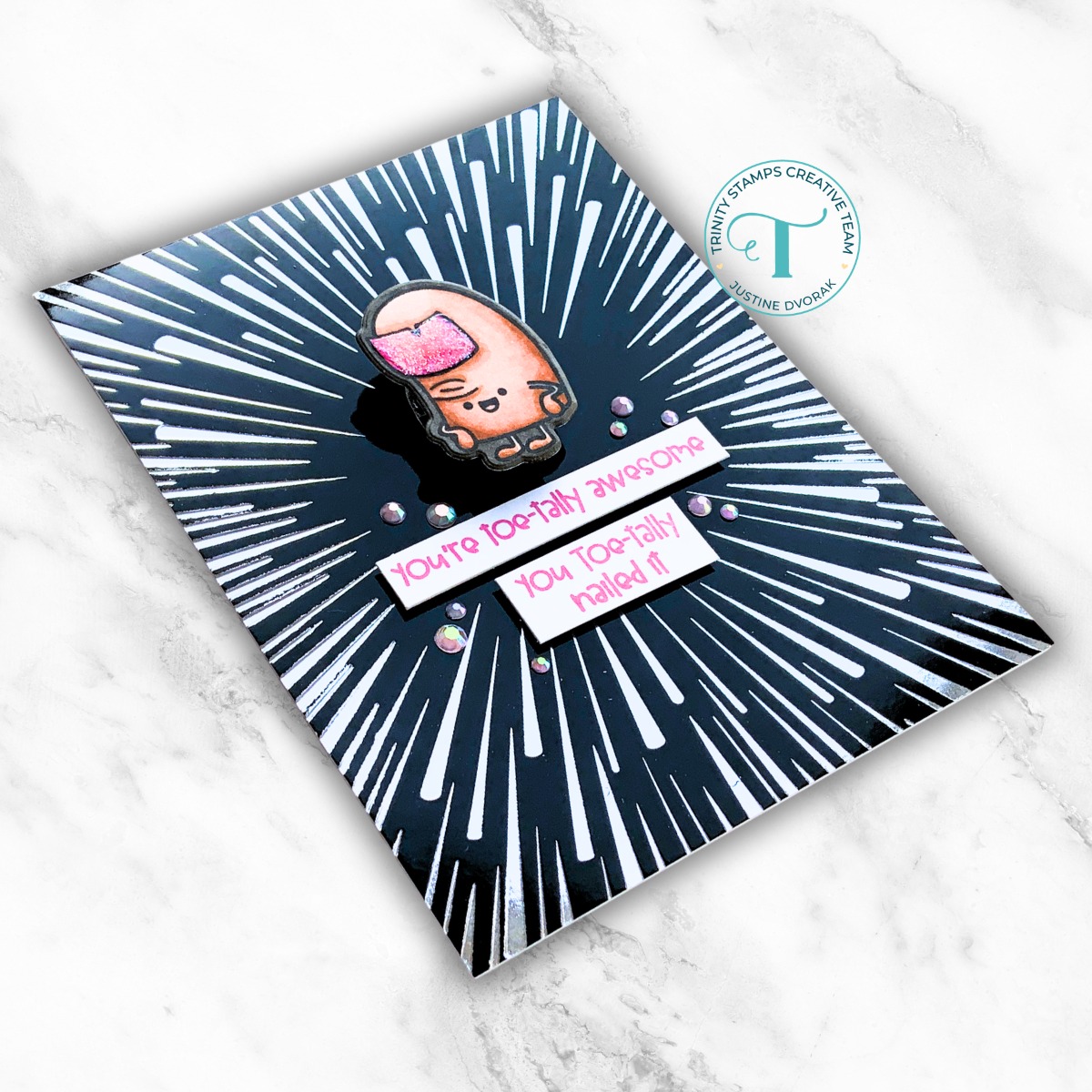 Greeting card with black background cartoon toe stating "you're toe-tally awesome" and "you toe-tally nailed it"