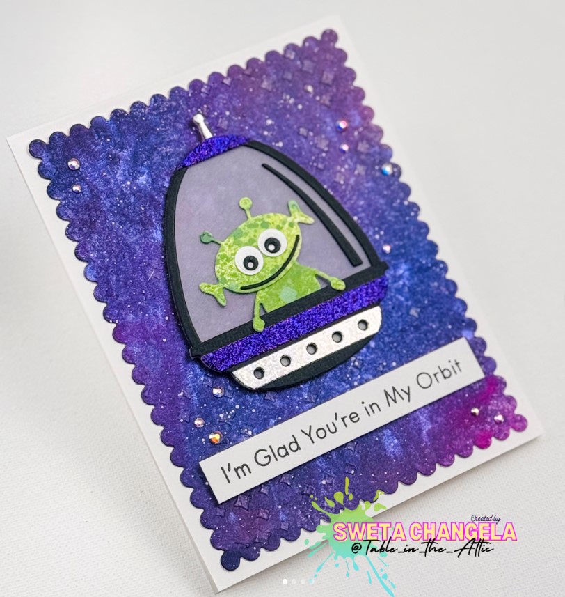 Greeting card featuring a tiny alien in a spaceship with a message reading "I'm Glad You're in My Orbit"