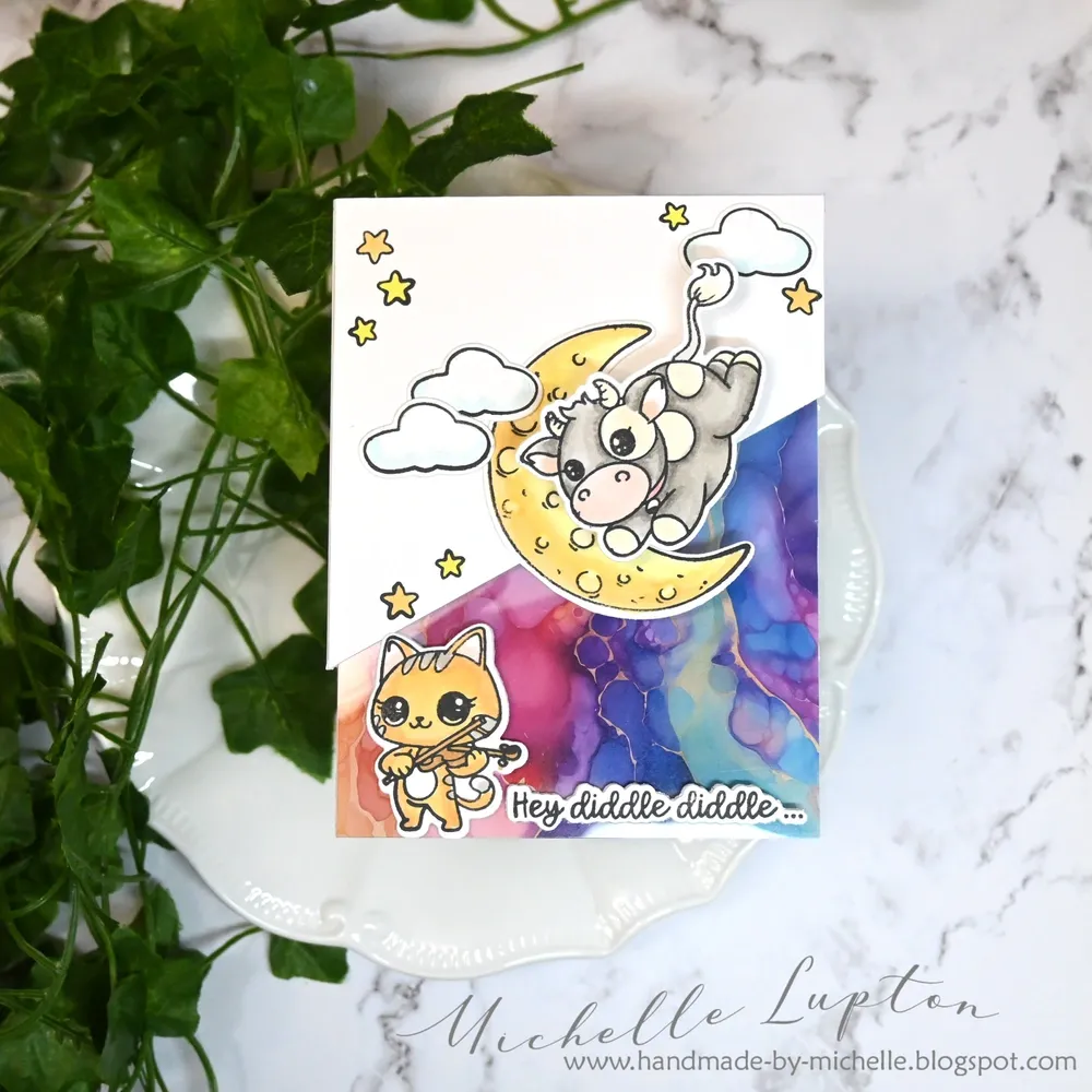 Greeting card featuring a cow jumping over a moon and a cat playing a fiddle