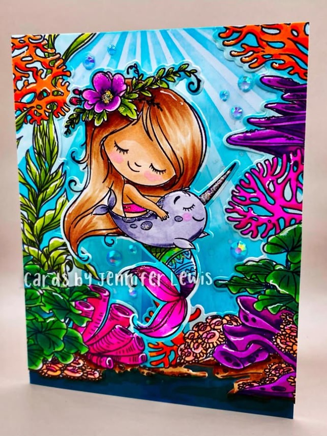 Greeting card featuring a young mermaid hugging a baby narwhal