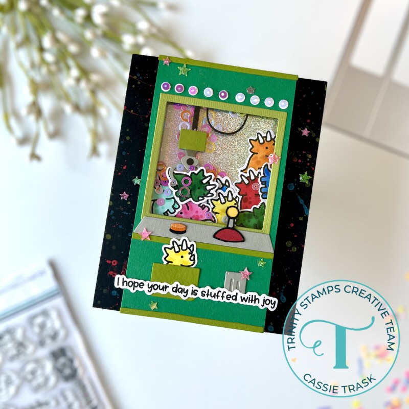 Claw machine greeting card with colorful stuffed dinos
