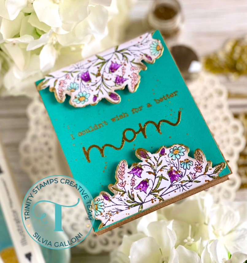 A deep teal greeting card with a white and purple floral bouquet and a message saying, "I couldn't wish for a better mom"