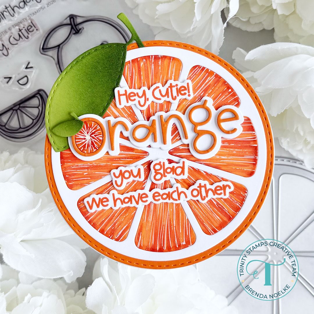 Realistic orange circle card reads "Hey, Cutie! Orange you glad we have each other"