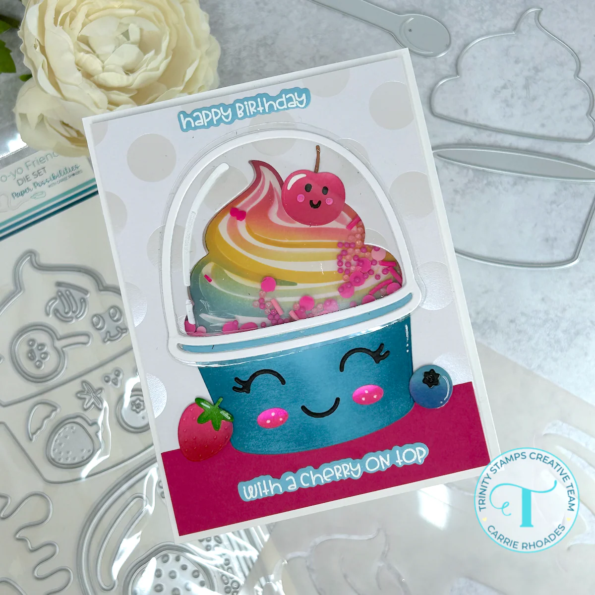 Rainbow swirl frozen yogurt in a blue cup and under domed lid. Covered in fruit and shaker elements. Reads "happy birthday with a cherry on top."