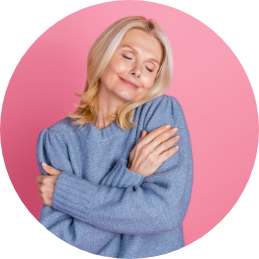 A Lifestyle image showing a woman feeling her soft cardigan