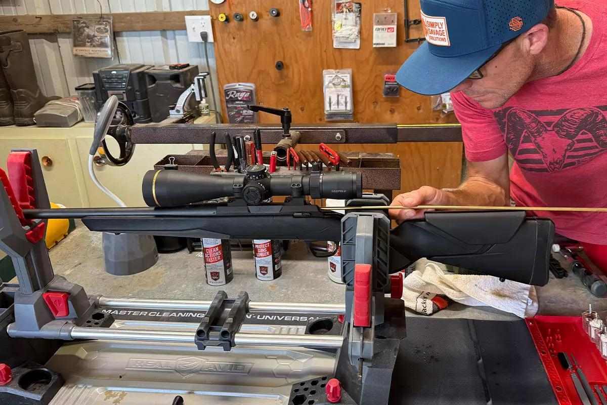 Man cleaning and leveling rifle