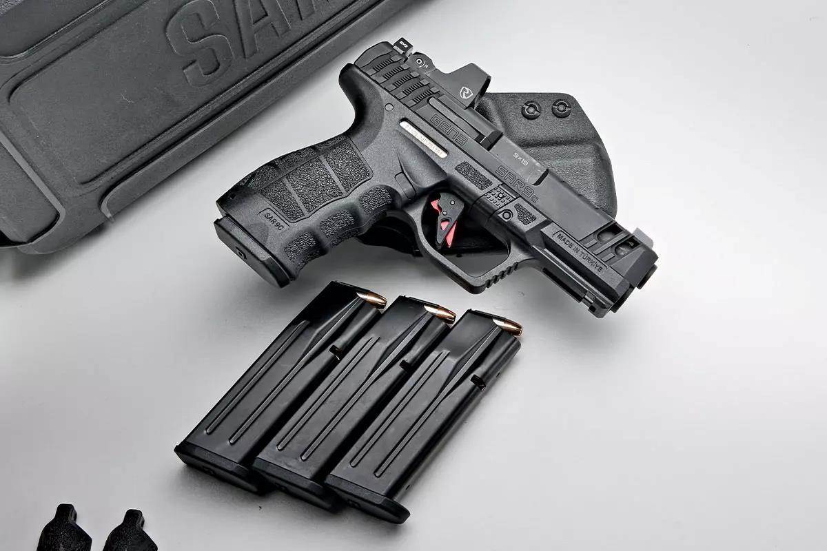 2 small, black handguns