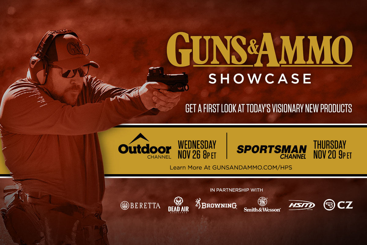 Man aiming gun at firing range with hearing protection on