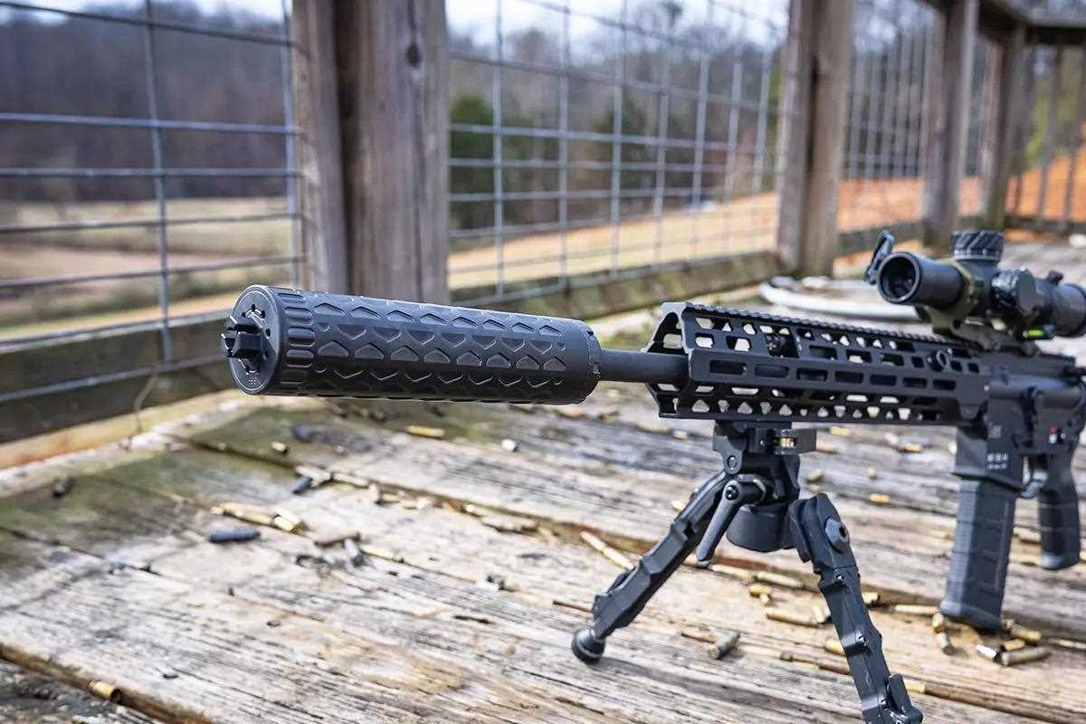 Large black rifle with suppressor