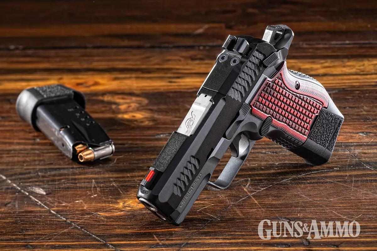 Black handgun with brown handle, with magazine displayed beside it