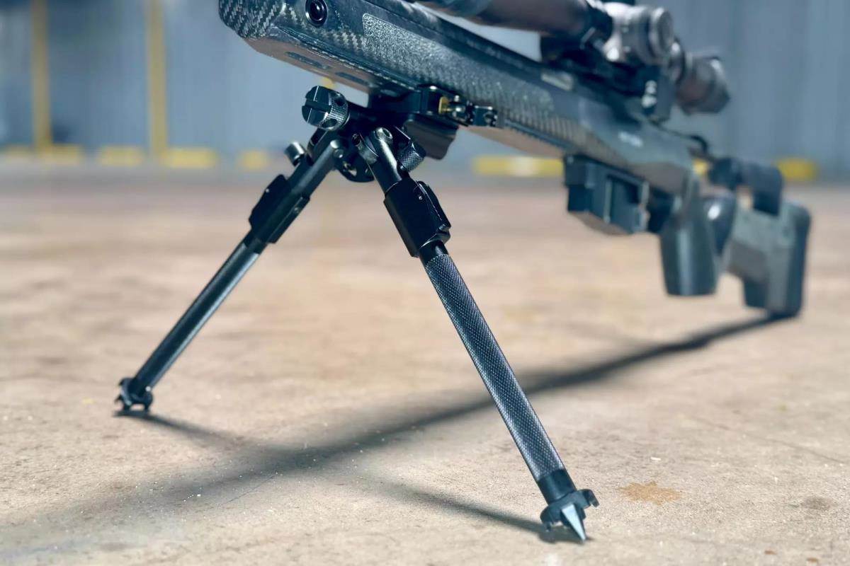 Black bipod with black rife attached