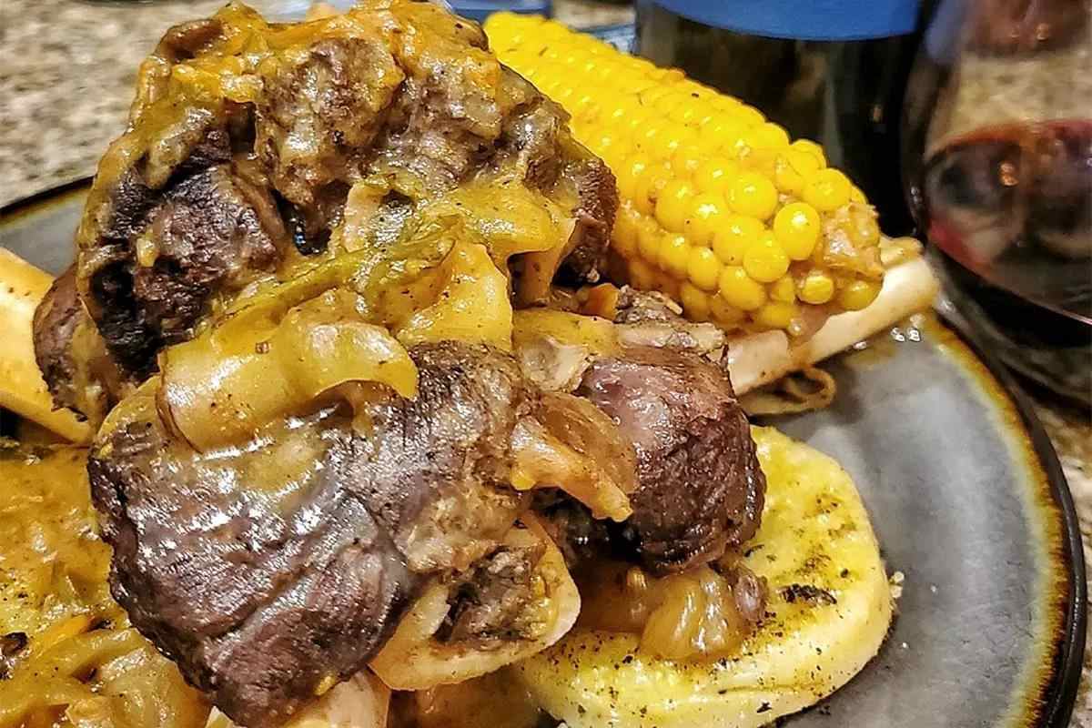 Moist venison shank with corn on the cob and potatoes