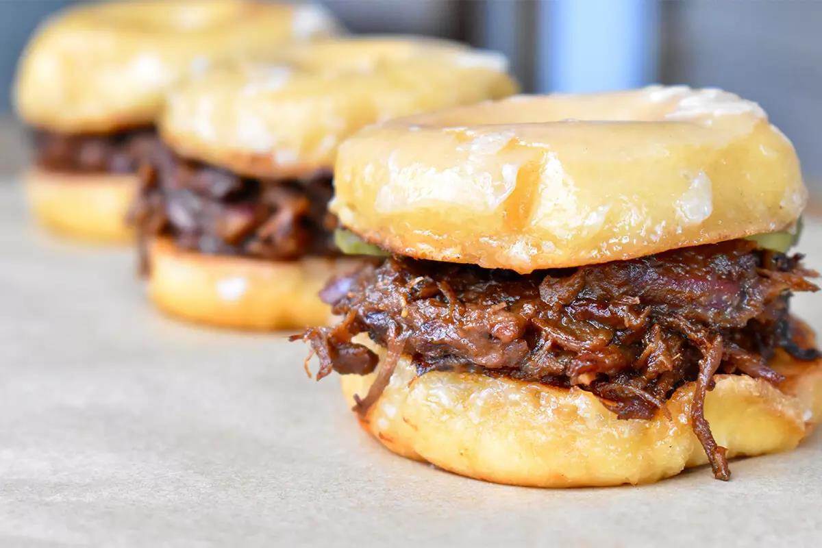 Gorgeous donut-as-a-bun shredded & sauced bear meat sliders