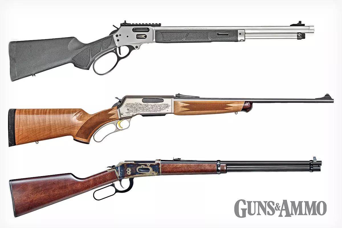3 different lever action guns of different metal and wood butts, displayed above one another