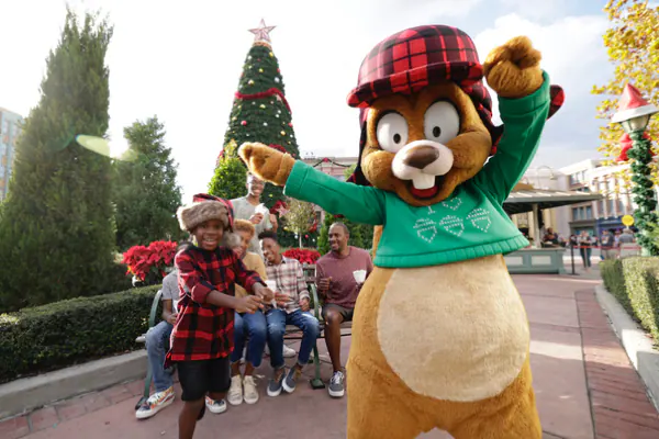 Earl the Squirrel and a young boy dance together during Holidays at Universal Orlando Resort.
