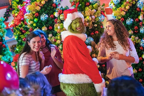 An image of guests celebrating with The Grinch™  at The Grinch™ & Friends Character Breakfast.