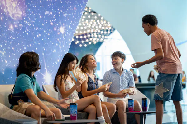 A family of three laughing and enjoying breakfast at Cabana Bay Beach Resort.