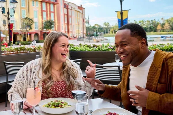 Two&nbsp;people&nbsp;sharing&nbsp;a&nbsp;meal&nbsp;and&nbsp;drinks&nbsp;at&nbsp;Trattoria&nbsp;del&nbsp;Porto&nbsp;at&nbsp;Loews&nbsp;Portofino&nbsp;Bay&nbsp;Hotel.