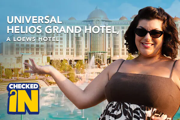 A happy guest showing the entrance of the Universal Helios Grand Hotel, a Lowes Hotel, with the text “CHECKED IN”.