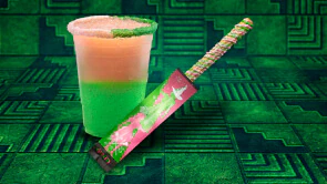 A pink and green drink and frosted churro in a Glinda-and-Elphaba WICKED wrapper