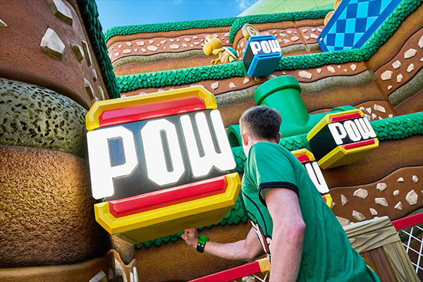 A man interacting with elements within SUPER NINTENDO WORLD.