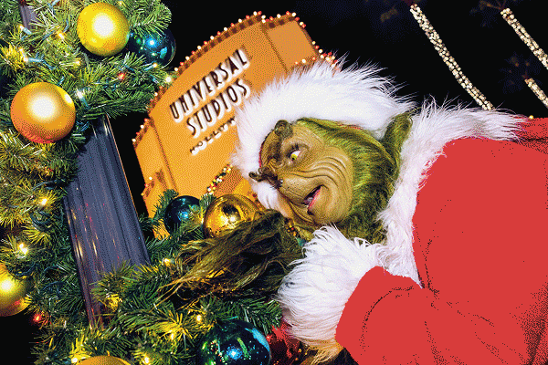 Image carousel of The Grinch dressed as Santa, two friends, standing back-to-back, under a holiday tree, and two kids smiling with their mom.