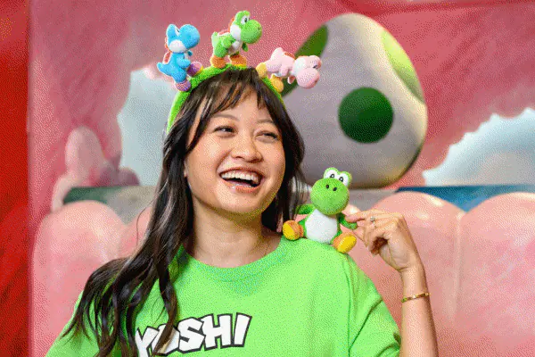 Rotating GIF of Guests posing with themed plush including Yoshis, Dungeons & Dragons characters and a Hippogriff.