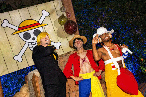 A rotation of 3 images of guests posing with Scooby Doo, guests standing with Frankenstein and guests dressed as characters from One Piece.