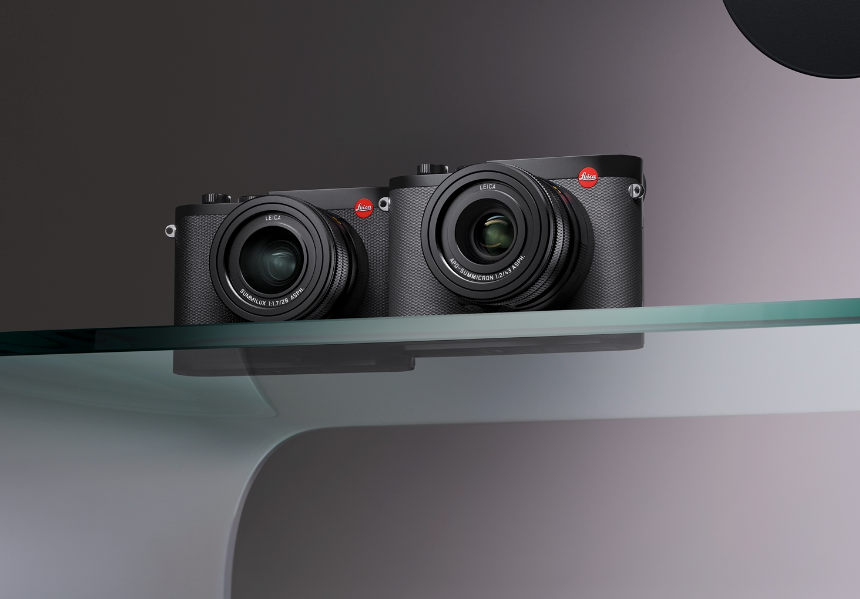 two leica cameras on a glass shelf