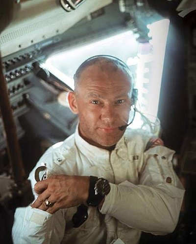 Astronaut wearing a watch while inside of a spacecraft.