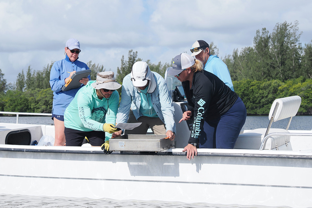 5 researchers on a motorboat