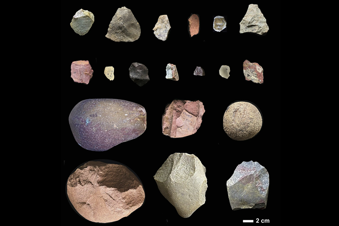 Stone tools of various colors on a black background